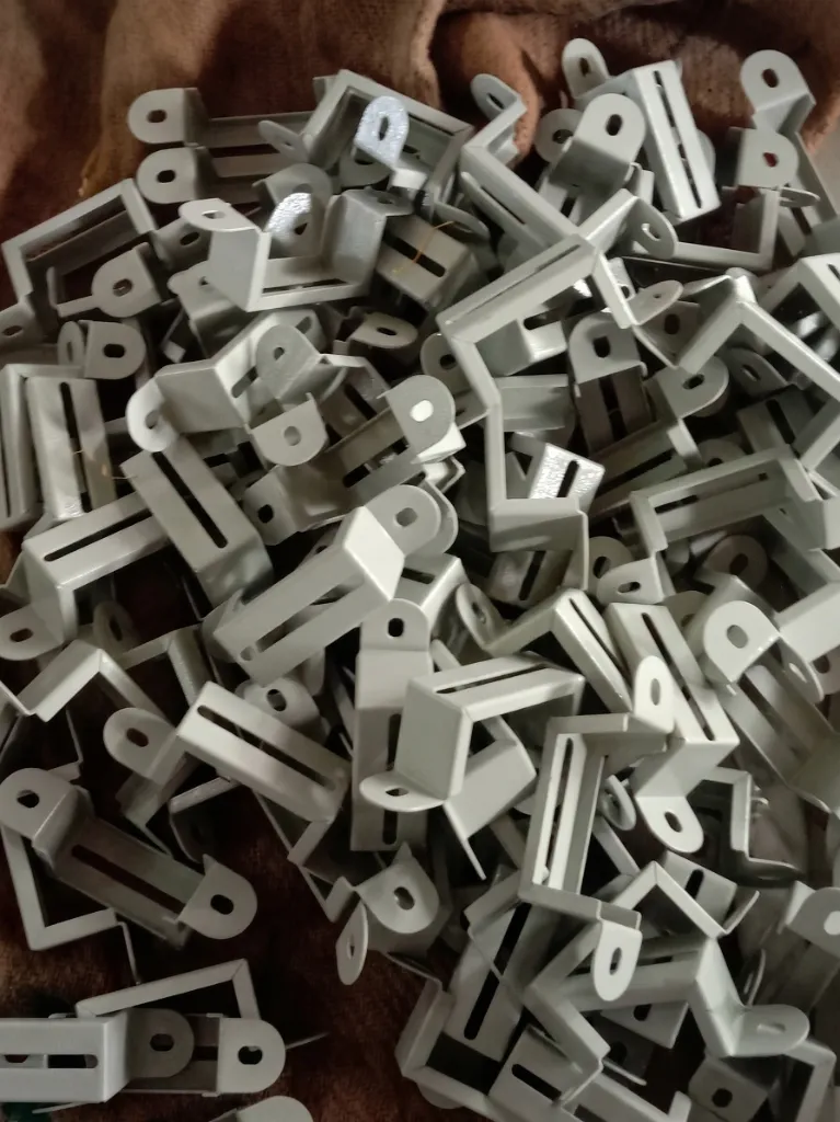 Bulk stock of powder-coated grey apartment clamps at SYK facility